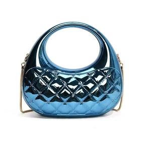 Detail of metallic blue evening bag with circular handle, quilted texture and gold chain