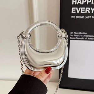 Metallic silver hobo bag with reflective mirror finish and thin metal chain strap