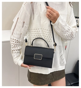 Chic black litchi grain leather crossbody bag styled with trendy gold metal buckle