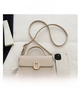 Macro shot of beige pebble leather texture with gold horseshoe buckle and strap detail