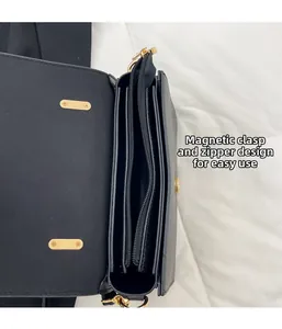 Detail view of black crossbody bag featuring secure magnetic clasp and zipper closure design