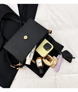 Detailed interior of the black lychee pattern bag showing large capacity and items