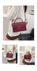 Detail of wine red crossbody bag with lychee grain texture and golden metal buckle