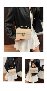 Detailed macro view of beige crossbody bag with lychee texture and golden metal lock