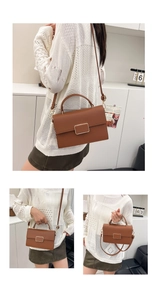 Detail view of brown lychee grain leather handbag with gold square buckle and strap
