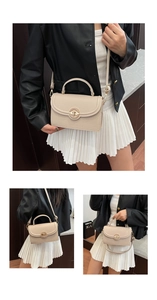 Detail view of beige lychee grain leather handbag with gold twist lock and adjustable strap