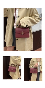 Detail of wine red pebbled leather shoulder bag with golden round decorative knob lock