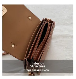 Detail view of the brown litchi pattern bag showing its three-layer internal structure