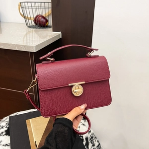 Elegant burgundy lychee pattern crossbody handbag with golden clasp and top handle