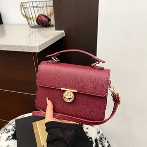 Classic burgundy lychee pattern satchel with a gold round lock and detachable shoulder strap