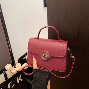 Retro burgundy pebble leather handbag with gold round lock and adjustable shoulder strap