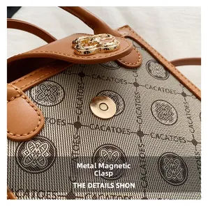 Detailed close-up of the vintage canvas texture and golden magnetic hardware buckle
