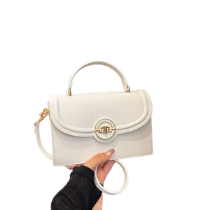Chic white lychee grain leather handbag with gold metal clasp and crossbody strap