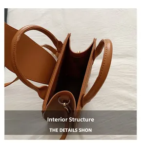 Detailed interior view of the brown vintage letter print shoulder bag with dual handles