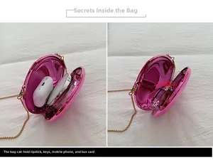 Detail view of pink metallic shell clutch bag with gold chain and interior storage compartments