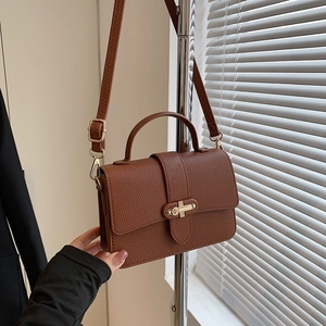 Brown litchi grain PU leather handbag with golden cross lock and adjustable strap