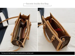 Vue détaillée du sac Boston marron avec monogramme montrant les compartiments et la fermeture