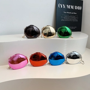 Modern egg-shaped metallic clutch bag set in seven vibrant colors with chain strap