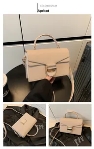 Detailed view of apricot shoulder bag with lychee texture and golden metal buckle clasp