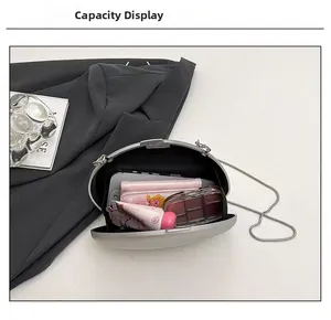 Detail showing the internal storage capacity of the oval silver evening clutch bag