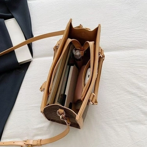 Detail view of the spacious monogram tote bag interior showing multiple storage compartments