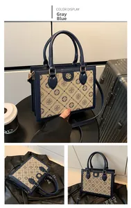Detail view of the elegant monogram print tote bag with blue trim and metal logo