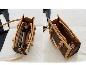 Detail view showing the spacious interior and compartments of the brown tote handbag