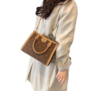 Classic brown monogram tote bag with leather handles and gold-tone hardware for women
