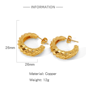 Detail view of twisted gold-plated copper earrings with size and material specifications