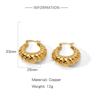 Detailed view of gold irregular textured croissant earrings made of brass, 12g weight