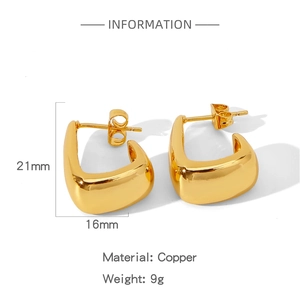 Detail view of gold U-shaped geometric copper earrings with weight and size specs