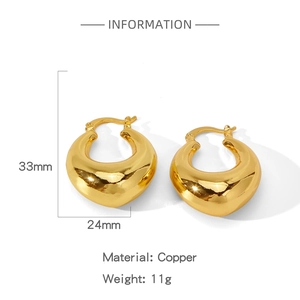 Macro view of 33mm gold chunky hoop earrings in polished copper with size dimensions