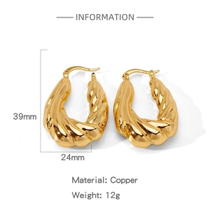 Detail view of twisted gold hoop earrings showing 39mm height and 24mm width dimensions