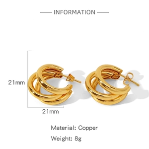 Detailed view of 21mm triple-layered gold circular earrings in polished copper material