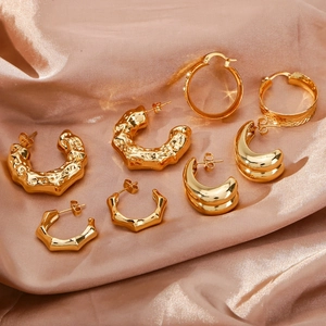 Elegante 18K vergoldete geometrische Ohrringe Kollektion auf Champagner-Seidenhintergrund