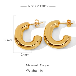 Detailed view of chunky golden C-shape copper earrings with 28mm diameter specifications