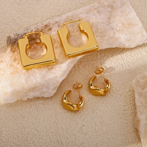 Polished gold geometric hoop earrings set with heart and square designs on natural stone