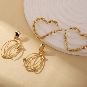 Boucles d'oreilles dorées exagérées en forme de cœur irrégulier et créoles texturées
