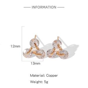 Detail showing geometric triangle stud earrings in copper with three sparkling zircons
