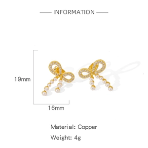 Detail view of brass butterfly stud earrings with micro-set zircons and pearl drops