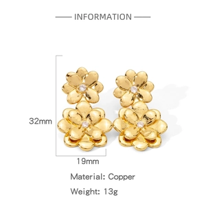 Detail view of gold-plated copper flower earrings with zircon centers measuring 32mm by 19mm