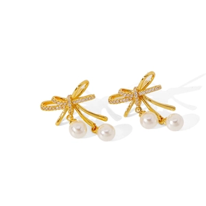 Elegant butterfly bow earrings with pavé crystals and white pearls on a clean white backdrop
