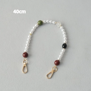 Detail of 40cm beaded bag chain with faux pearls, colored acrylic beads and gold clasps