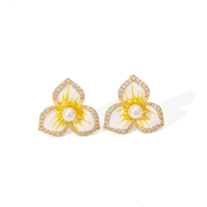 Elegant gold flower earrings with white enamel petals, pearls, and sparkling zircon stones
