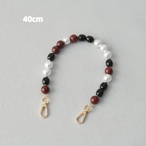 Detail view of 40cm acrylic bead strap with golden metal lobster clasps for bags
