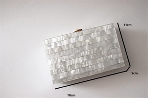 Detailed view of pearlescent acrylic evening clutch with 18x11x5cm size dimensions