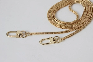 Macro detail of golden 3mm snake bone metal chain strap with secure spring lobster clasps