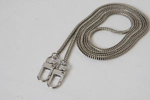 Macro view of 3mm silver metal flat snake chain strap with shiny lobster clasps