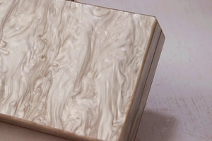 Close-up of the elegant marble texture on this off-white pearlescent acrylic evening clutch bag