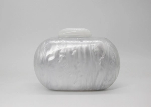 Detailed close-up showing the white marble pearl texture of the acrylic clutch bag